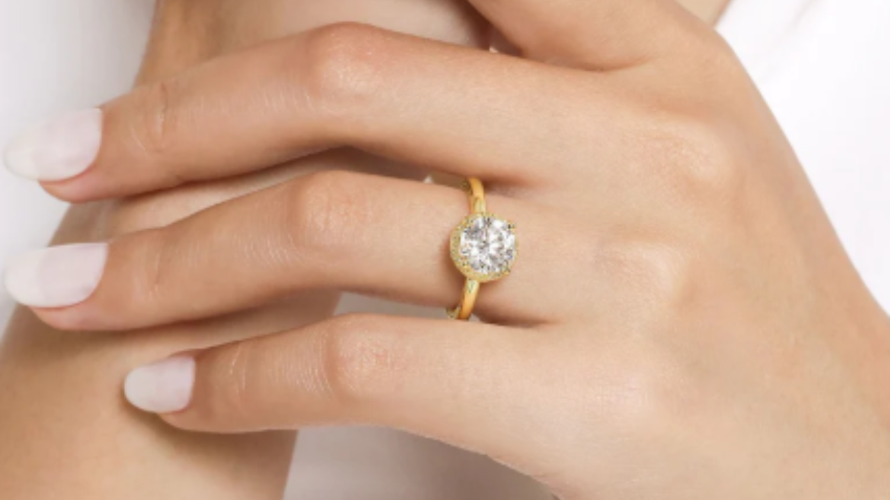 A 14K Yellow Gold Round halo engagement ring available at Dunkin’s Diamonds.