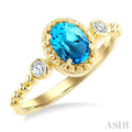 7X5 MM Oval Cut Blue Topaz and 1/20 Ctw Round Cut Diamond Semi-Precious Beaded Ring in 10K Yellow Gold
