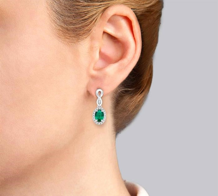 5x3 MM Oval Cut Emerald and 1/6 Ctw Round Cut Diamond Earrings in 10K White Gold