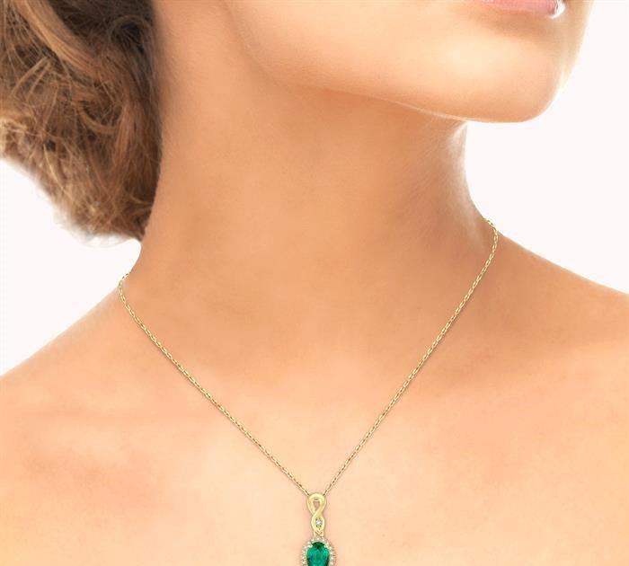6x4 MM Oval Cut Emerald and 1/10 Ctw Round Cut Diamond Pendant in 10K Yellow Gold with Chain