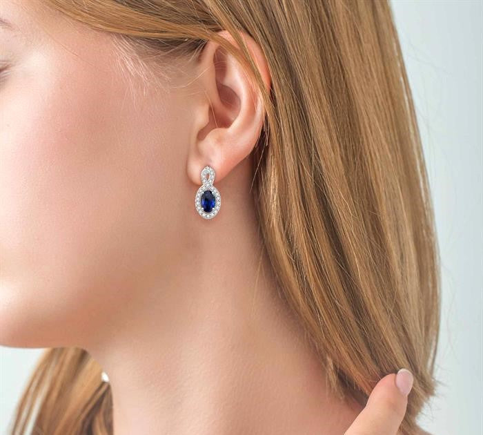 5x3 MM Oval Cut Sapphire and 1/5 Ctw Round Cut Diamond Earrings in 10K White Gold