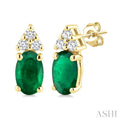 1/20 Ctw Oval Cut 5X3 MM Emerald and Round Cut Diamond Precious Earrings in 14K Yellow Gold