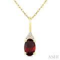 1/50 Ctw Oval Cut 6X4 MM Garnet and Round Cut Diamond Semi-Precious Pendant With Chain in 14K Yellow Gold
