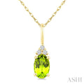 1/50 Ctw Oval Cut 6X4 MM Peridot and Round Cut Diamond Semi-Precious Pendant With Chain in 14K Yellow Gold
