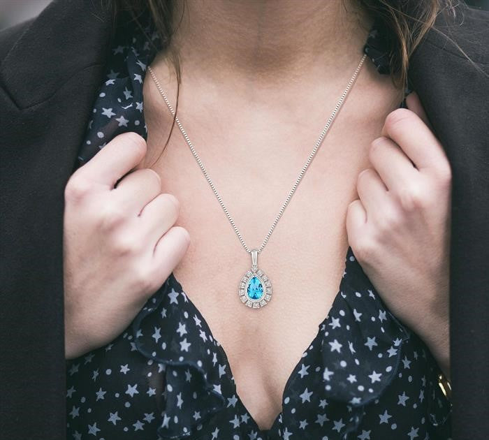 9x6 MM Pear Shape Blue Topaz and 1/10 Ctw Round Cut Diamond Semi-Precious Pendant With Chain in 10K White Gold