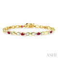 4x3 MM Oval Cut Ruby and 1/10 Ctw Round Cut Diamond Bracelet in 14K Yellow Gold