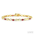 4x3 MM Oval Cut Ruby and 1/10 Ctw Round Cut Diamond Bracelet in 10K Yellow Gold