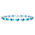 6X4 MM Oval Cut Blue Topaz and 1/6 Ctw Round Cut Diamond Semi-Precious Tennis Bracelet in 10K White Gold