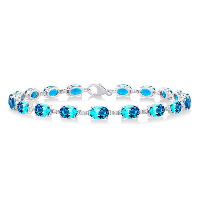 6X4 MM Oval Cut Blue Topaz and 1/6 Ctw Round Cut Diamond Semi-Precious Tennis Bracelet in 10K White Gold