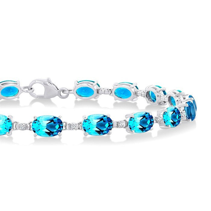 6X4 MM Oval Cut Blue Topaz and 1/6 Ctw Round Cut Diamond Semi-Precious Tennis Bracelet in 10K White Gold