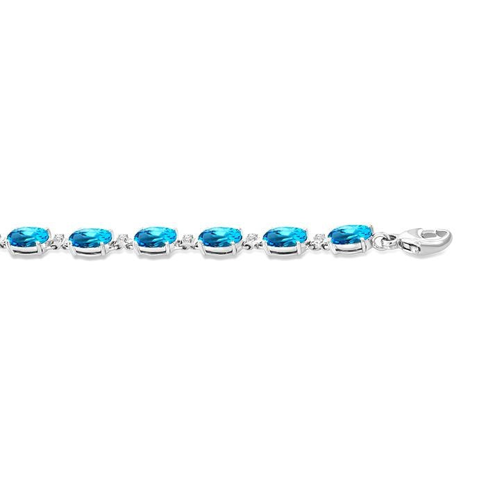 6X4 MM Oval Cut Blue Topaz and 1/6 Ctw Round Cut Diamond Semi-Precious Tennis Bracelet in 10K White Gold
