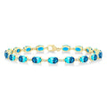 6X4 MM Oval Cut Blue Topaz and 1/6 Ctw Round Cut Diamond Semi-Precious Tennis Bracelet in 10K Yellow Gold