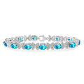 7x5 MM Oval Cut Blue Topaz and 1/10 Ctw Round Cut Diamond Semi-Precious Bracelet in Sterling Silver
