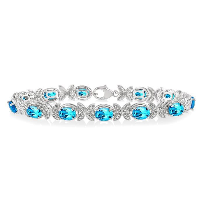 7x5 MM Oval Cut Blue Topaz and 1/10 Ctw Round Cut Diamond Semi-Precious Bracelet in Sterling Silver