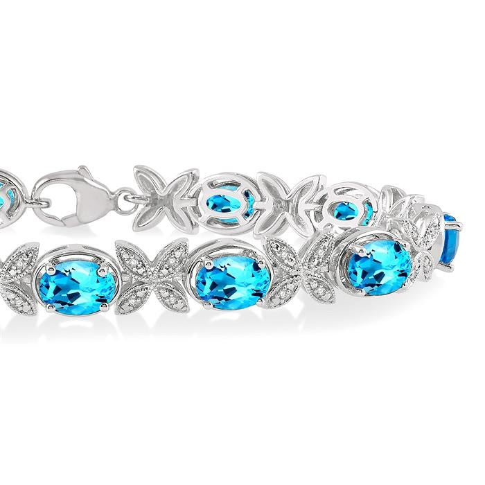 7x5 MM Oval Cut Blue Topaz and 1/10 Ctw Round Cut Diamond Semi-Precious Bracelet in Sterling Silver