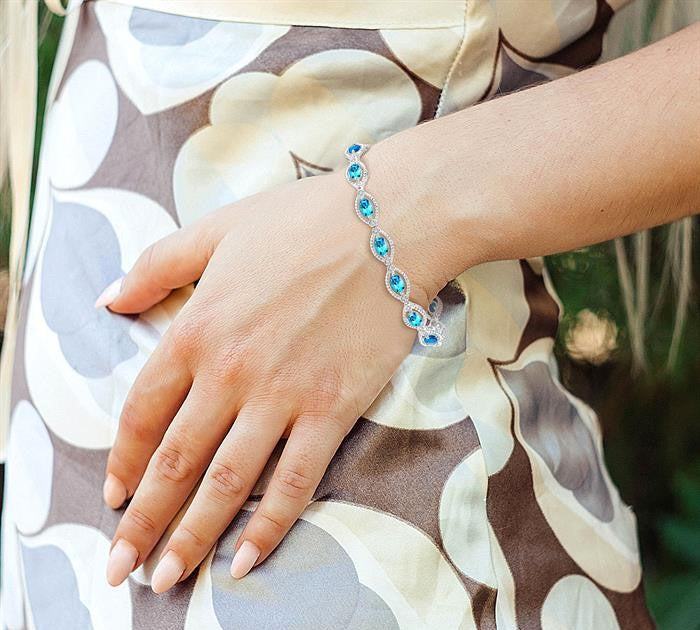 6x4 MM Oval Cut Blue Topaz and 1/10 Ctw Round Cut Diamond Semi-Precious Bracelet in Sterling Silver