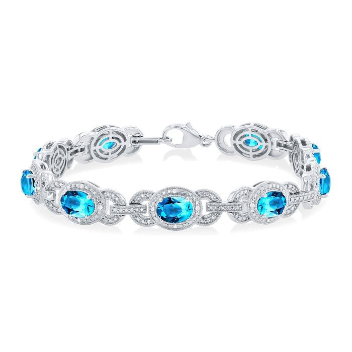 7x5 MM Oval Shape Blue Topaz and 1/10 Ctw Round Cut Diamond Semi-Precious Bracelet in Sterling Silver
