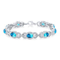 Oval Shape Blue Topaz and 1/10 Ctw Round Cut Diamond Semi-Precious Bracelet