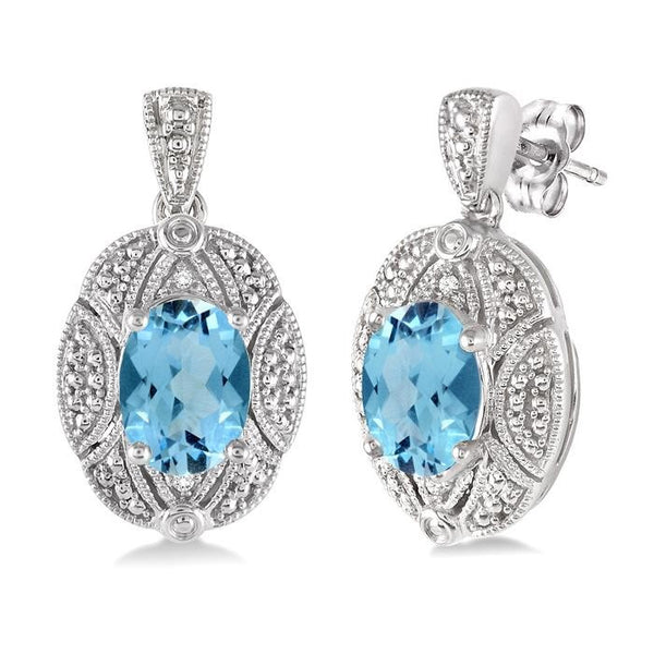 8x6 MM Oval Cut Blue Topaz and 1/50 Ctw Round Cut Diamond Earrings in Sterling Silver