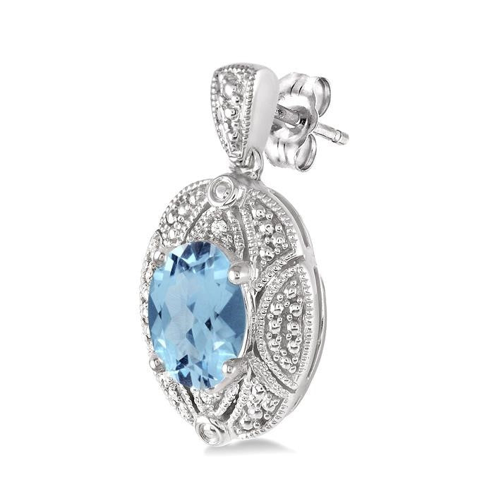 8x6 MM Oval Cut Blue Topaz and 1/50 Ctw Round Cut Diamond Earrings in Sterling Silver