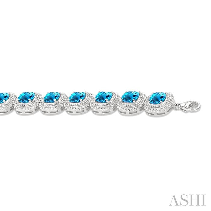 7 MM Oval Shape Blue Topaz and 1/10 Ctw Round Cut Diamond Semi-Precious Bracelet in Sterling Silver