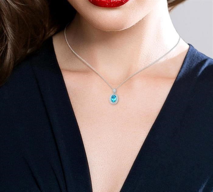 8X6 MM Oval Cut Blue Topaz and 1/20 Ctw Round Cut Diamond Semi-Precious Pendant With Chain in Sterling Silver