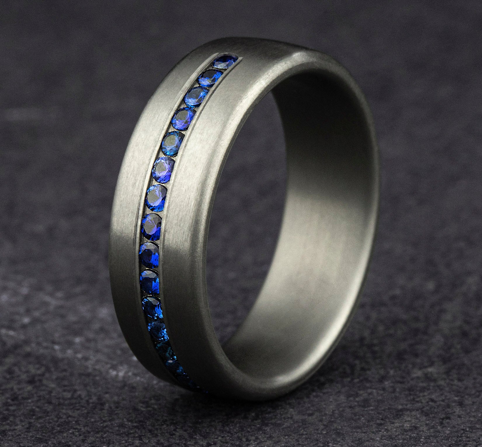 THE VISCOUNT 7.5mm, Comfort fit, Grey Tantalum, Satin finish, 20 channel set blue sapphires, Carat weight is .40ct