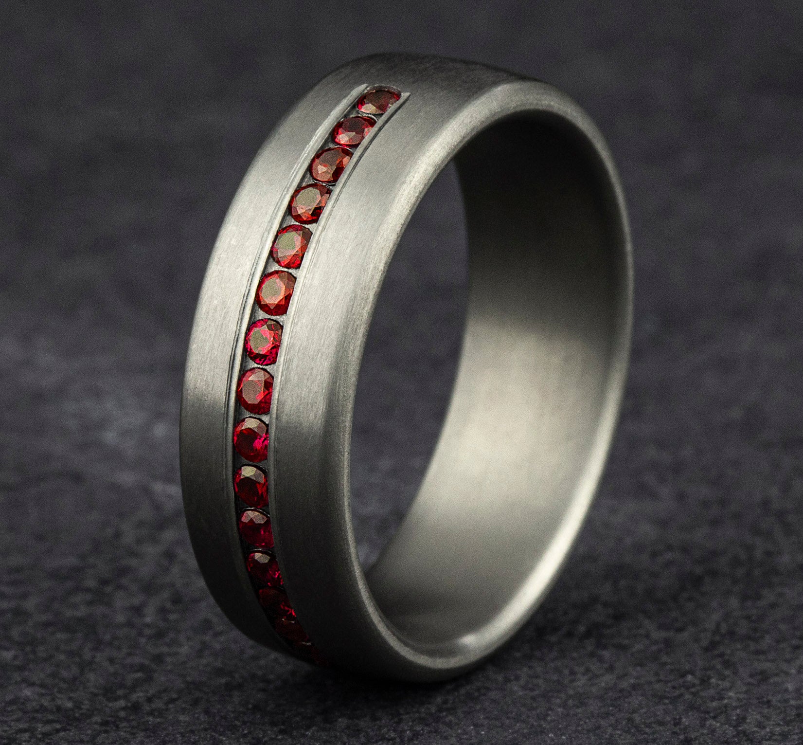 THE CARDINAL 7.5mm, Comfort fit, Grey Tantalum, Satin finish, 20 channel set rubies, Carat weight is .40ct