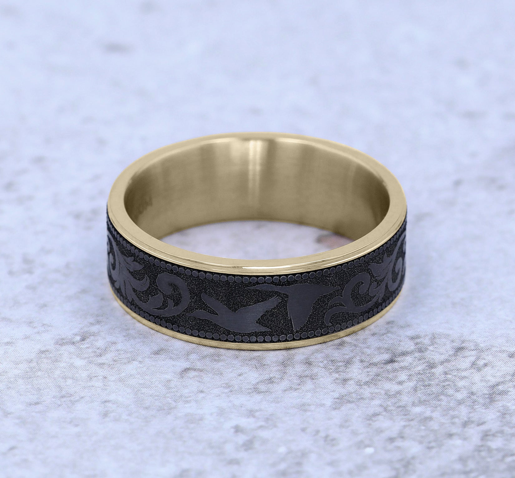 THE WATERFOWL 7.5mm, Comfort fit, 14K Yellow Gold and Black Titanium, Flying duck and script patterned center, thin edges