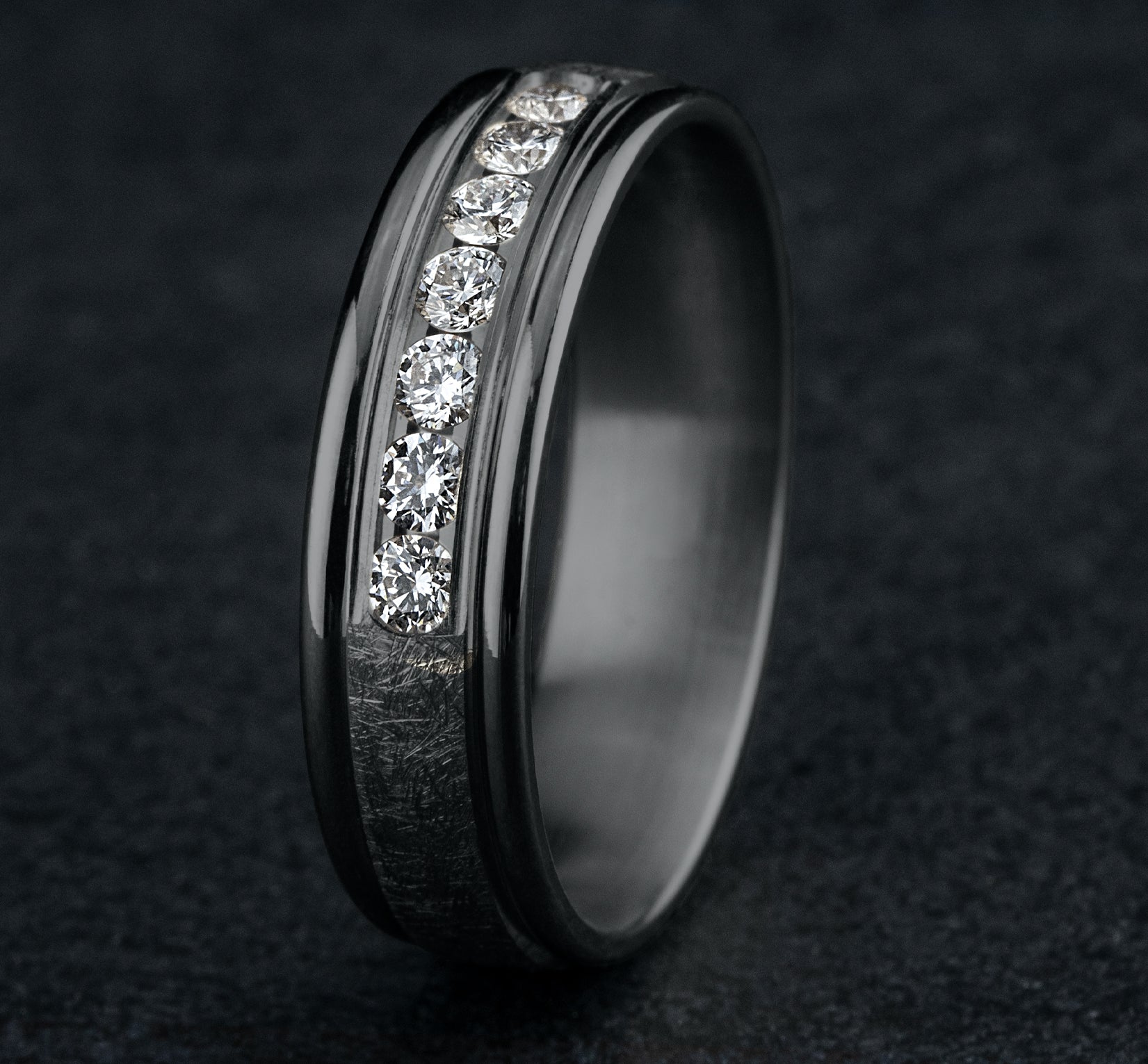 THE CAMBRIDGE 6.5mm, Comfort fit, Grey Tantalum, Swirl finish, polished round edges, 7 channel set diamonds, Carat weight is .42ct, Clarity SI1-2, Color GH